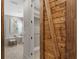 Stylish bathroom entrance showcasing barn door, a tub, and a walk-in closet at 2612 Leafwing Ct, Palm Harbor, FL 34683