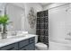 Nicely appointed bathroom with decorative wall art and shower-tub with an eye-catching curtain at 2612 Leafwing Ct, Palm Harbor, FL 34683