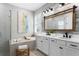 Elegant bathroom with a soaking tub, a double vanity, and modern fixtures at 2612 Leafwing Ct, Palm Harbor, FL 34683