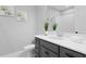 Stylish bathroom features a gray vanity with white countertop, framed mirror, and shower-tub combo at 2612 Leafwing Ct, Palm Harbor, FL 34683