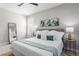 Well-lit bedroom with a large bed, stylish decor, and ample natural light at 2612 Leafwing Ct, Palm Harbor, FL 34683