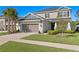 Charming two-story home with lush landscaping, a two-car garage and a well-manicured lawn at 2612 Leafwing Ct, Palm Harbor, FL 34683