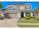 Charming two-story home with a two-car garage and well-manicured lawn and front garden at 2612 Leafwing Ct, Palm Harbor, FL 34683