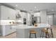 Modern kitchen with white cabinets, stainless steel appliances, and a large center island with stool seating at 2612 Leafwing Ct, Palm Harbor, FL 34683
