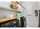Well-equipped laundry room with wood countertop and storage cabinets at 2612 Leafwing Ct, Palm Harbor, FL 34683