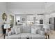 Bright living room showcasing an open floor plan with modern decor leading into a kitchen with stainless steel appliances at 2612 Leafwing Ct, Palm Harbor, FL 34683