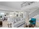 Bright and airy living room with high ceilings, a modern staircase, and an open floor plan at 2612 Leafwing Ct, Palm Harbor, FL 34683