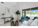 Bright living room featuring a sliding glass door with outdoor furniture and modern decor at 2612 Leafwing Ct, Palm Harbor, FL 34683