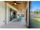 Relaxing screened-in patio with ceiling fans and seating, offering a delightful outdoor living space at 2612 Leafwing Ct, Palm Harbor, FL 34683