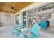 Inviting covered patio with an open view of the great room and dining room with stylish furnishings at 2612 Leafwing Ct, Palm Harbor, FL 34683