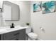 Powder room with stylish gray vanity and a decorative mirror at 2612 Leafwing Ct, Palm Harbor, FL 34683