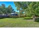 Expansive backyard with lush green lawn, mature trees, and a privacy fence at 2749 Bent Leaf Dr, Valrico, FL 33594