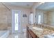 Bathroom featuring tiled shower, granite countertop vanity, and door to the exterior at 2749 Bent Leaf Dr, Valrico, FL 33594