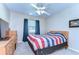 Bright bedroom with a large window and comfortable bed featuring patriotic themed bedding at 2749 Bent Leaf Dr, Valrico, FL 33594