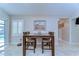 Dining area with wooden table and chairs is well-lit and open to backyard through sliding glass doors at 2749 Bent Leaf Dr, Valrico, FL 33594