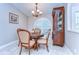 Charming dining room featuring a round table, chandelier, and a large window with plantation shutters at 2749 Bent Leaf Dr, Valrico, FL 33594