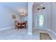 Elegant foyer with marble floors, decorative lighting, and an arched entrance to the dining area at 2749 Bent Leaf Dr, Valrico, FL 33594
