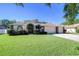 Charming single-story home with a well-manicured lawn, a two-car garage and a welcoming front entrance at 2749 Bent Leaf Dr, Valrico, FL 33594