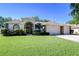 Charming home featuring a manicured lawn, brick accents, arched doorway and a three car garage at 2749 Bent Leaf Dr, Valrico, FL 33594