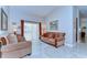 Cozy living room with marble floors, comfortable seating, and sliding doors to the backyard at 2749 Bent Leaf Dr, Valrico, FL 33594