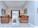Inviting living room area with marble flooring, comfortable seating and views of the backyard at 2749 Bent Leaf Dr, Valrico, FL 33594