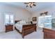 Comfortable main bedroom features carpeting, a ceiling fan, and natural light, creating a relaxing retreat at 2749 Bent Leaf Dr, Valrico, FL 33594