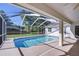 Sparkling in-ground swimming pool surrounded by a screened enclosure and a spacious patio area at 2749 Bent Leaf Dr, Valrico, FL 33594