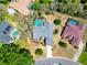 Aerial view showcasing a home with a gray roof, blue pool, and well-maintained landscaping at 2910 Pine Club Dr, Plant City, FL 33566