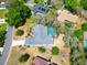 Aerial view highlighting a home with a blue pool, long drive way, and lush green landscaping at 2910 Pine Club Dr, Plant City, FL 33566