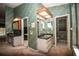 En-suite bathroom with double vanity, framed mirrors, and separate toilet room and access to tub/shower at 2910 Pine Club Dr, Plant City, FL 33566