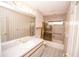 Bright bathroom features a vanity with a gold faucet, a bathtub with shower, and gold accents at 2910 Pine Club Dr, Plant City, FL 33566