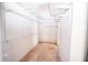 Walk-in closet with white metal shelving and neutral carpeting, perfect for organizing wardrobe and accessories at 2910 Pine Club Dr, Plant City, FL 33566
