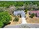 Aerial shot displaying a single-Gathering home with well-kept landscaping and a two-car garage at 2910 Pine Club Dr, Plant City, FL 33566