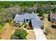 Aerial shot of a well maintained single-Gathering house with lush landscaping and neutral colors at 2910 Pine Club Dr, Plant City, FL 33566