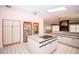 Spacious kitchen with island, stainless steel appliances, and a bright skylight creating a welcoming atmosphere at 2910 Pine Club Dr, Plant City, FL 33566