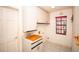 Functional laundry room includes cabinets, sink, and a window at 2910 Pine Club Dr, Plant City, FL 33566