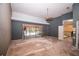Living room with sliding glass door to pool and access to second floor staircase at 2910 Pine Club Dr, Plant City, FL 33566