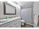 Bathroom featuring a modern vanity, white marble countertop, and tiled shower at 3147 Mission Grove Dr # 3147, Palm Harbor, FL 34684
