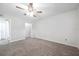 Empty bedroom with carpet, ceiling fan, and access to closet and bathroom at 3147 Mission Grove Dr # 3147, Palm Harbor, FL 34684