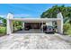 Spacious carport with ample parking for multiple vehicles, along with additional storage space at 3147 Mission Grove Dr # 3147, Palm Harbor, FL 34684