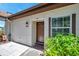 Close up of the front entrance with a traditional wood door, lantern, and address number 3147 at 3147 Mission Grove Dr # 3147, Palm Harbor, FL 34684