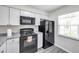 Well-equipped kitchen with white cabinets, modern appliances, and a window providing natural light at 3147 Mission Grove Dr # 3147, Palm Harbor, FL 34684