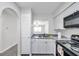 Bright kitchen featuring white cabinetry, stylish countertops, and modern appliances at 3147 Mission Grove Dr # 3147, Palm Harbor, FL 34684