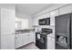 Well-equipped kitchen with white cabinets, modern appliances, and stylish countertops at 3147 Mission Grove Dr # 3147, Palm Harbor, FL 34684