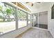 Bright sunroom with tiled floors and windows looking out to lush greenery at 3147 Mission Grove Dr # 3147, Palm Harbor, FL 34684