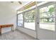 Enclosed sunroom with tiled floor and multiple windows providing ample sunlight at 3147 Mission Grove Dr # 3147, Palm Harbor, FL 34684