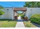 Charming walkway with covered entrance surrounded by well-manicured landscaping at 3147 Mission Grove Dr # 3147, Palm Harbor, FL 34684