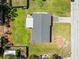 Aerial view showcasing a home's layout, roof, driveway, and surrounding greenery at 3210 Acacia St, Lutz, FL 33558