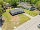 Aerial view of a charming home with a well-manicured lawn and brick driveway at 3210 Acacia St, Lutz, FL 33558