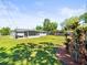 Large backyard with a screened porch and lush landscaping at 3210 Acacia St, Lutz, FL 33558